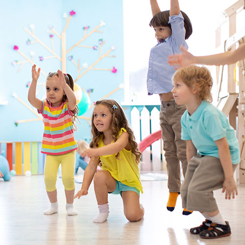 pre-school kids jumping indoors